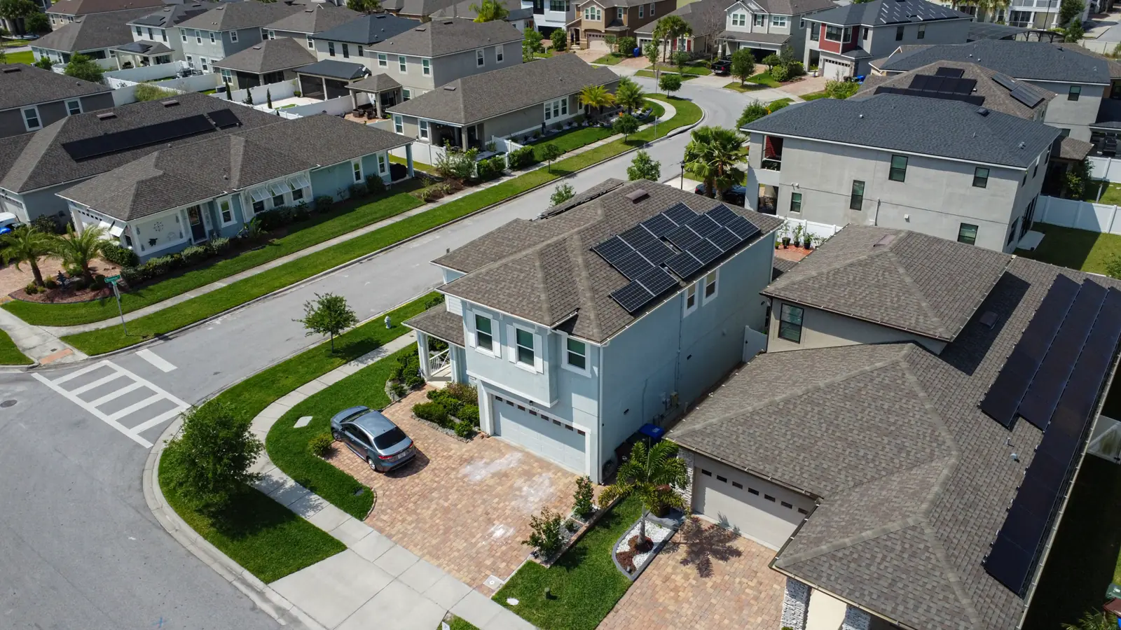 Aerial view of a Florida neighborhood with rooftop solar panels